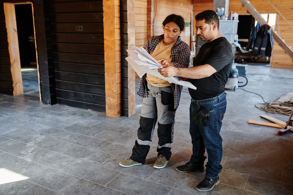 General contractor reviewing home addition blueprints